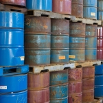 Rows of stacked steel barrels of various colors