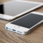 White iPad and iPhone 5s at workspace