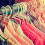 Clothes hang on a shelf in a designer clothes store in retro col