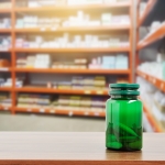 Medicine plastic bottle on table with pharmacy