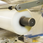 Conveying machine beltlinewith roll of polyethylene film