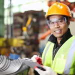Portrait of young engineer taking notes