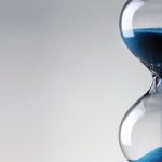 Time passing. Blue hourglass.