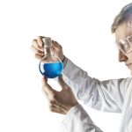 Silhouette of a chemist conducting experiments on the background