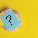 question marks written reminders tickets on yellow paper background