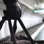 Close up of terrorist holding black bag in hand, possibly timebo