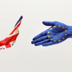 Male hands colored in United Kingdom and European Unity flags