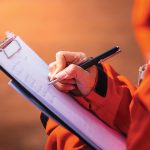 Safety officer/Supervisor is writing note on the checklist paper