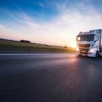 Loaded European truck on motorway in sunset