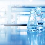 water in beaker and flask glass in chemistry blue science labora