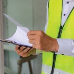 foreman builder, engineer or inspector in green safety vest refl