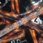 Top-down view of fast-moving cars on a highway, intense traffic