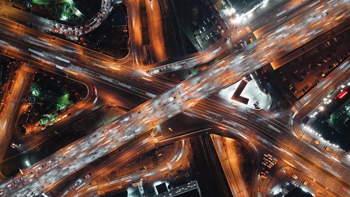 Top-down view of fast-moving cars on a highway, intense traffic