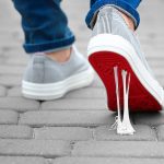 Foot stuck into chewing gum on street. Concept of stickiness