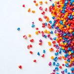 Colorful Plastic Granules Scattered on a White Background, Creat