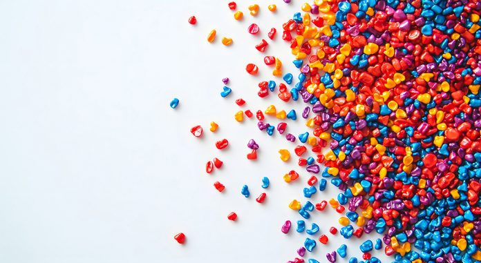 Colorful Plastic Granules Scattered on a White Background, Creat